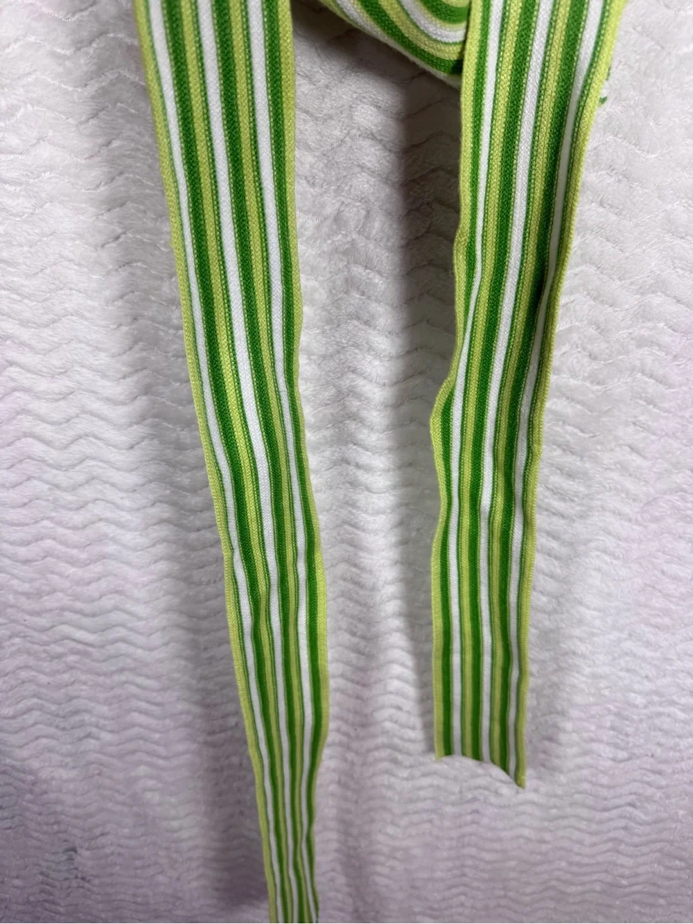 Cider striped halter top features a distinctive tie-back design vibrant green
